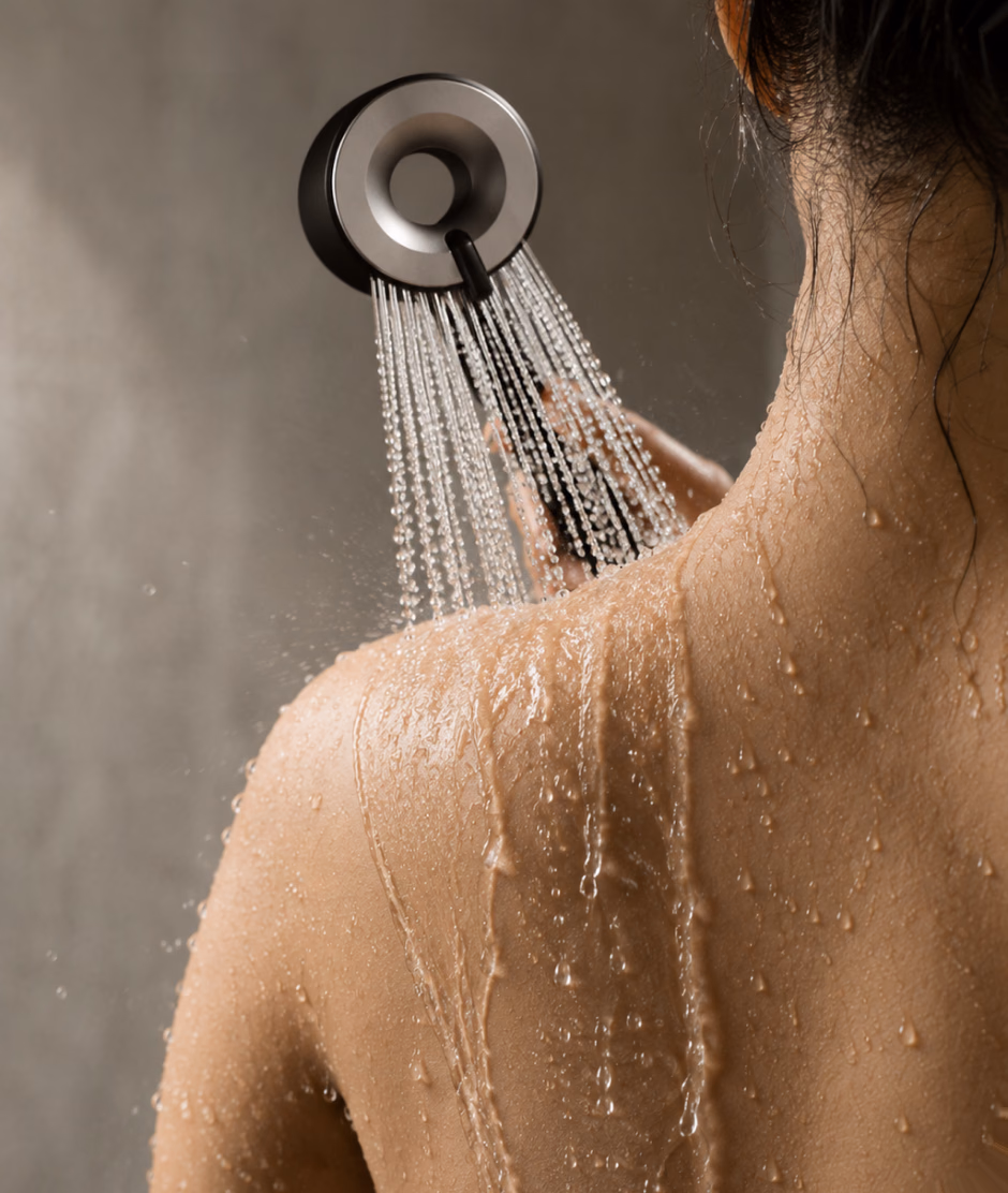 Water from the IonDrops shower head running down a woman's shoulder